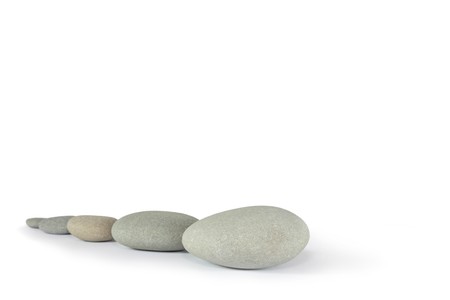 Zen abstract of five gray spa stones, over white background. Focus on the front stone.