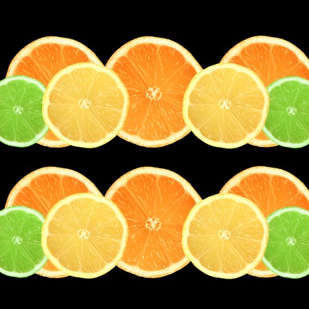 Lemon, lime and orange citrus fruit slices in two lines over black background.の写真素材