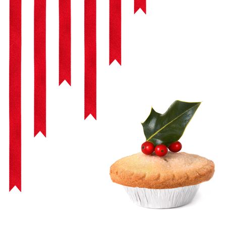 Christmas mince pie with holly leaf sprig and berries with red ribbons to one side, over white background.の写真素材