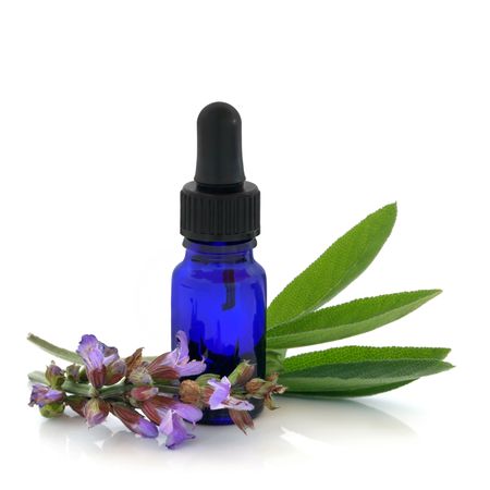  Sage herb flowers and leaves with an aromatherapy essential oil dropper bottle, over white background.の写真素材