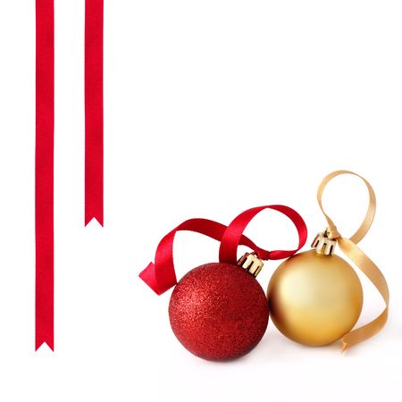  Christmas  red and gold baubles with ribbons to one side, over white background.の写真素材