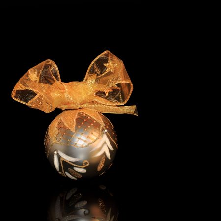 Luxury sparkling christmas silver bauble  with gold ribbon, over white background with reflection.の写真素材