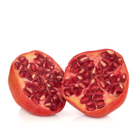 Pomegranate fruit in halves, isolated over white background.の写真素材