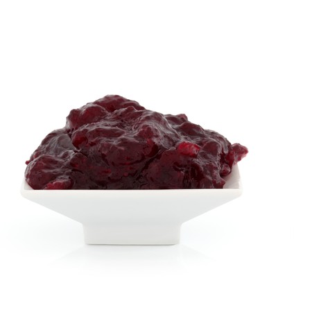 Cranberry sauce in a white porcelain dish, served with turkey at thanksgiving and christmas, isolated over white background.の写真素材