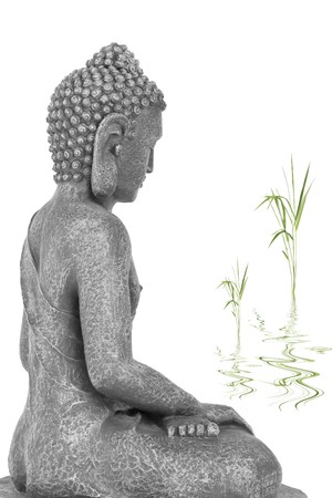 Buddha in meditation, with bamboo leaf grass with reflection in rippled water, isolated over white background. Mass produced statue.の写真素材