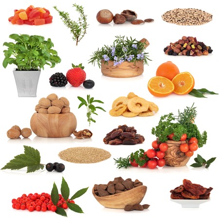 Healthy super food collection of fresh and dried fruit, nuts, herbs, spices, and pluses, very high in antioxidants and vitamins, isolated over white background.の写真素材