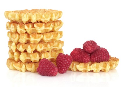 Waffle stack with fresh raspberries, isolated over white background.の写真素材