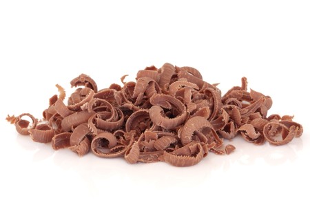 Grated chocolate in a pile isolated over white background.の写真素材