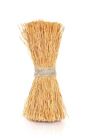 Wok cleaning natural bristle brush tied  with string, isolated over white background.の写真素材