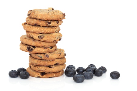 Blueberry cookies in a stack with loose blueberries, over white background.の写真素材