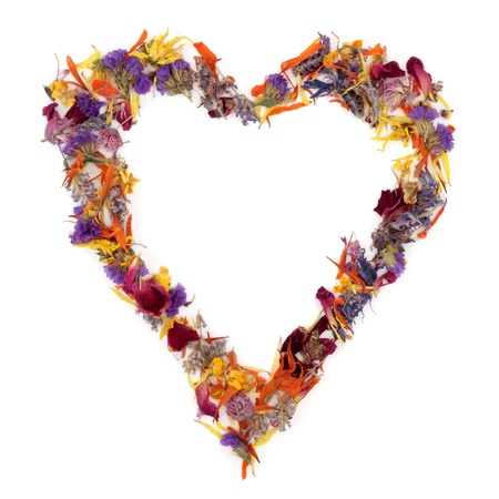 Heart shaped wreath of dried herb and flower petal mixture, over white background.の写真素材