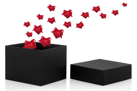  Black gift box open with lid to one side and heart shaped baubles with ribbons and bows, isolated over white background.の写真素材
