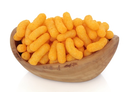 Cheese puff crisps in a rustic olive wood bowl, over white background.の写真素材