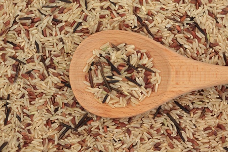 Wild rice in a wooden spoon and forming a background.の写真素材
