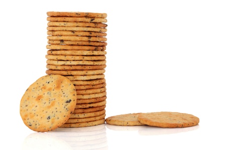Olive cracker biscuits in a stack and loose, over white background.の写真素材