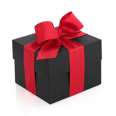 Black gift box with red satin ribbon and bow, over white background.の写真素材