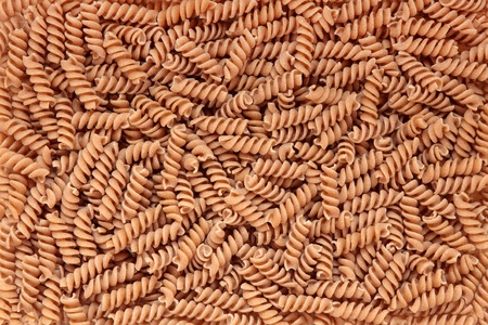 Fusilli pasta made with durham wheat forming a textured background.の写真素材