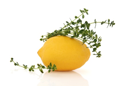 Lemon fruit with lemon thyme herb leaf sprig isolated over white background.の写真素材