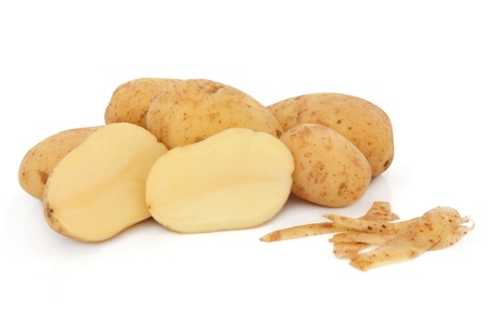 Maris piper potato group, whole and sliced with peel isolated over white background.の写真素材