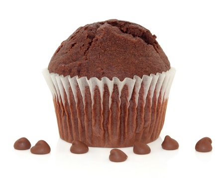 Chocolate chip muffin cup cake with loose chips isolated over white background.の写真素材