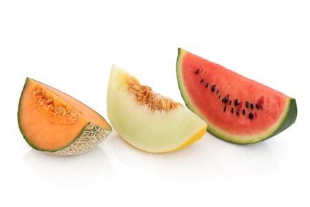 Melon slices of cantaloupe, honeydew and red watermelon isolated over white background の写真素材