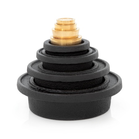 Cast iron and brass imperial cooking weights over white background 