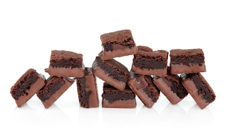 Chocolate brownie cakes in a random pile over white background の写真素材