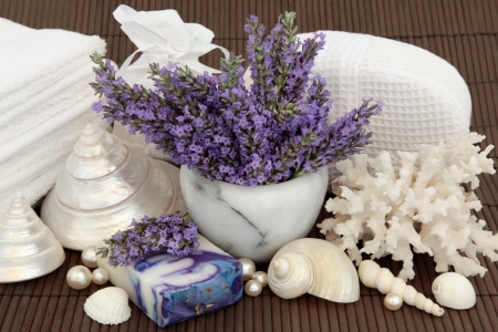 Lavender herb flowers with spa and bathroom accessories over bamboo background の写真素材