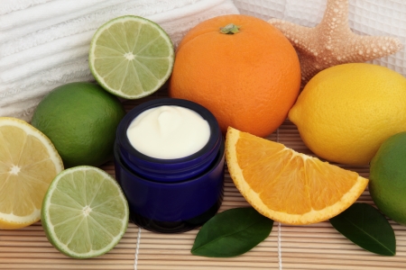 Spa and bathroom accessories with lemon, orange and lime fruit and over bamboo background の写真素材
