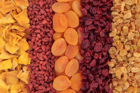 Dried fruit forming a background of mango, goji berry, apricot, cranberry and golden raisins の写真素材