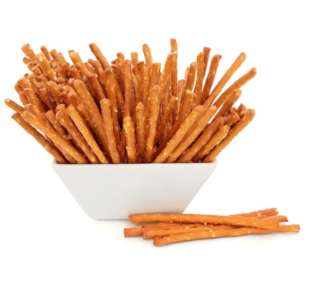 Pretzel snacks in a porcelain bowl over white background 