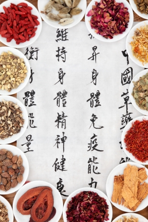 Traditional chinese herbal medicine with mandarin script calligraphy on rice paper  Translation describes the functions to increase the bodys ability to maintain body and spirit health and to balance energy の写真素材