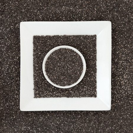 Chia seed health food in white square and round porcelain dishes の写真素材