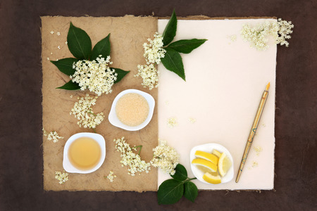 Elderflower champagne ingredients with old pen over natural hemp notebook and lokta paper background.の写真素材