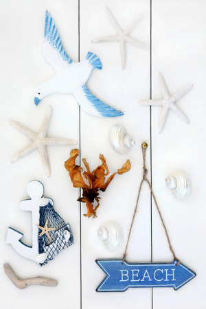 Abstract of seaside symbols with beach sign over wooden white background.の写真素材