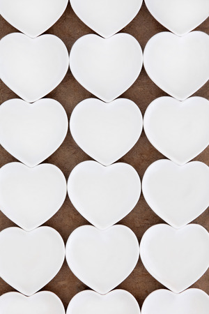 White heart shaped porcelain bowls in abstract design.の写真素材
