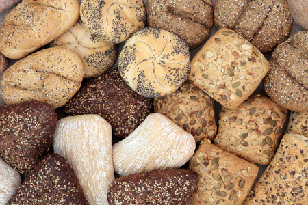 Fresh bread roll selection forming an abstract background.