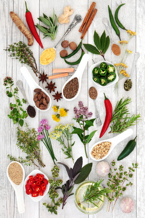 Large health food herb and spice seasoning selection over distressed white wood background.の写真素材