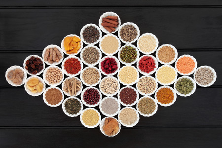 Large dried health food sampler in china bowls forming an abstract background. High in antioxidants,...