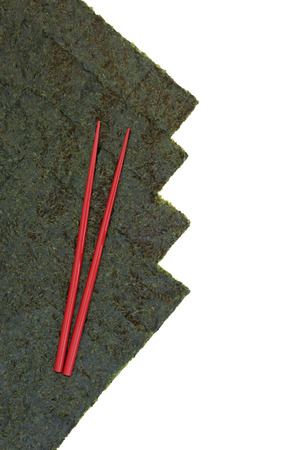 Japanese nori seaweed with red chopsticks on white background with copy space.の写真素材