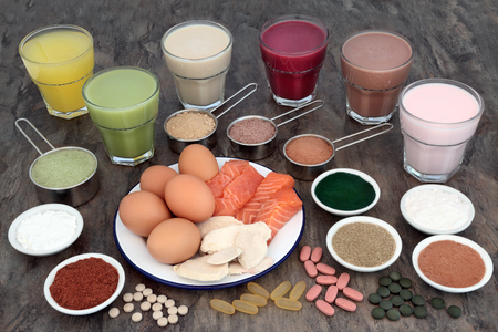 Health food and health drinks for body builders with high protein meat, fish, eggs and supplement powders with vitamin pills.の写真素材
