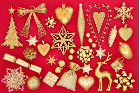 Christmas bauble decorations and symbols in gold on red background.の写真素材