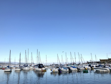 Lyme Regis, Dorset, United Kingdom. 21st August 2017. Sailing and speed boats in the harbour at Lyme Regis on a blue sky day in summer.のeditorial素材