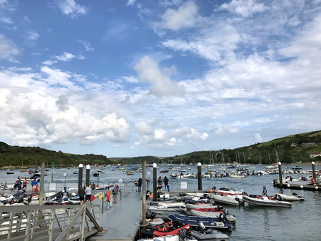 Salcombe, West Hams, Devon, United Kingdom. 31st August 2017. Salcombe harbour Devon, UK with ferry terminal on a jetty and small leisure craft moored on the water  With unidentified people.のeditorial素材