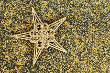 Christmas gold star bauble tree decoration with glitter background. Christmas card for the festive holiday season.の写真素材