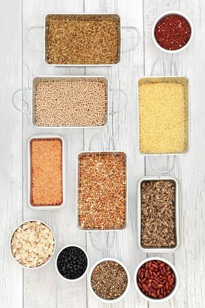 Dried health food for liver detox  with grains, seeds, cereals and legumes in metal dishes on rustic white woodの写真素材