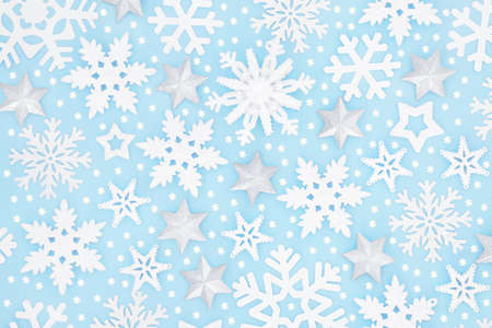 Christmas snowflake & silver star background pattern on pastel blue. Festive design for winter, Xmas...