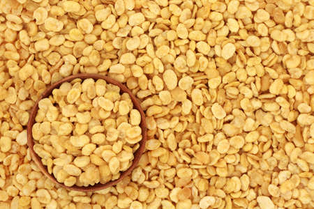 Fava beans for a healthy vegan & vegetarian diet snack food in a wooden bowl forming a background....