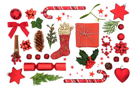 Christmas composition with red bauble decorations, winter holly, ivy, mistletoe, fir & gift related...