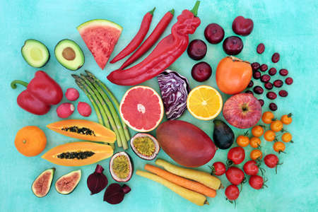 Immune boosting healthy food for good health high in lycopene, anthocyanins, antioxidants,vitamins, minerals & dietary fibre. With fruit & vegetables on mottled blue. Healthcare concept. Flat lay.の写真素材